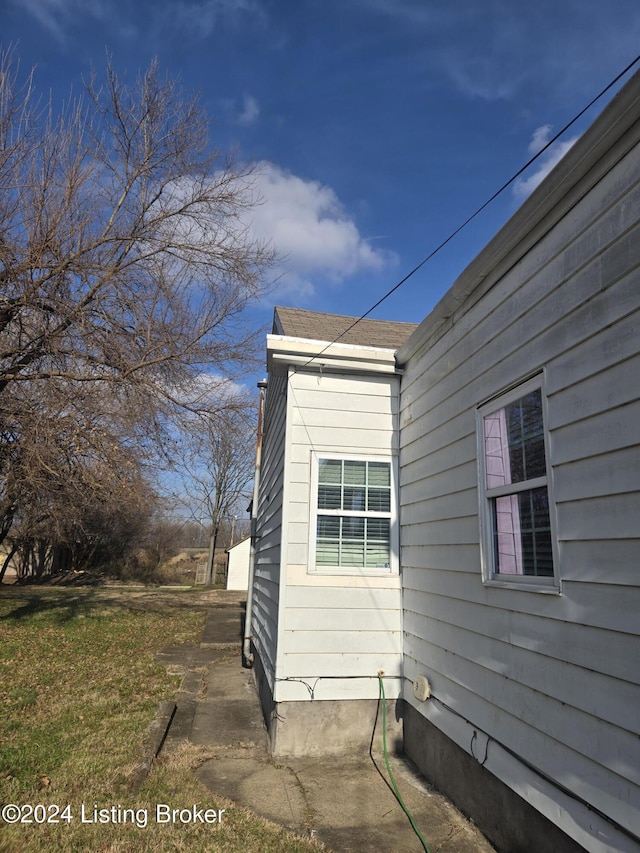 view of side of home with a lawn