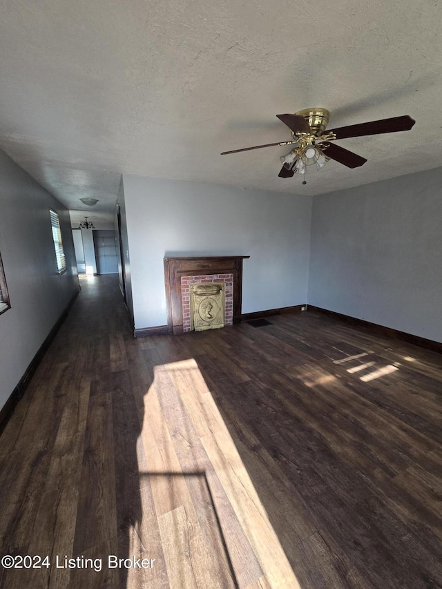 unfurnished living room with ceiling fan, dark wood-type flooring, and a textured ceiling