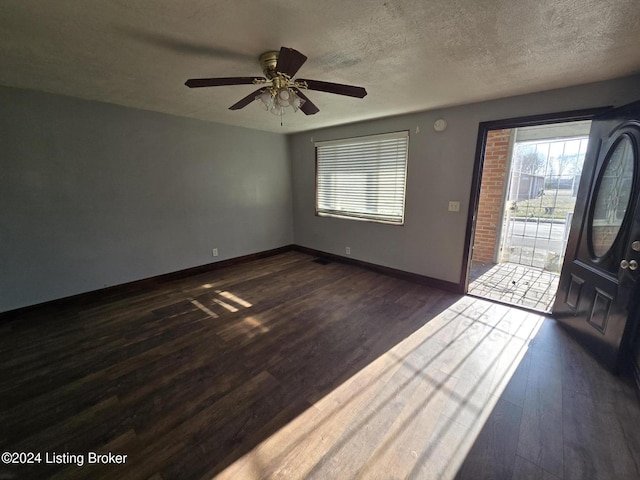 entrance foyer featuring a textured ceiling, dark hardwood / wood-style floors, and ceiling fan