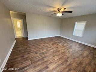 spare room with dark hardwood / wood-style floors and ceiling fan