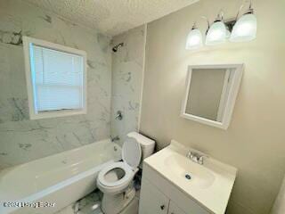 full bathroom with vanity, toilet, a textured ceiling, and tiled shower / bath combo