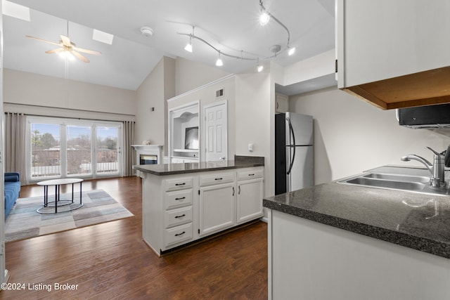 kitchen featuring stainless steel refrigerator, sink, white cabinets, and dark hardwood / wood-style floors