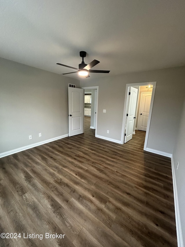 unfurnished bedroom with dark hardwood / wood-style floors and ceiling fan