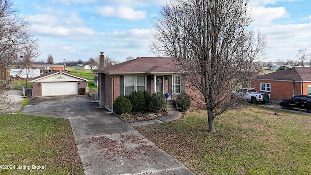 view of front of property with a garage, a front lawn, and an outdoor structure