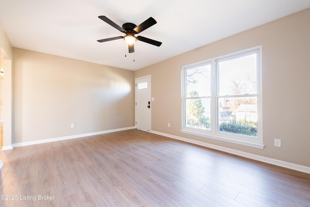 empty room featuring ceiling fan and light wood-type flooring