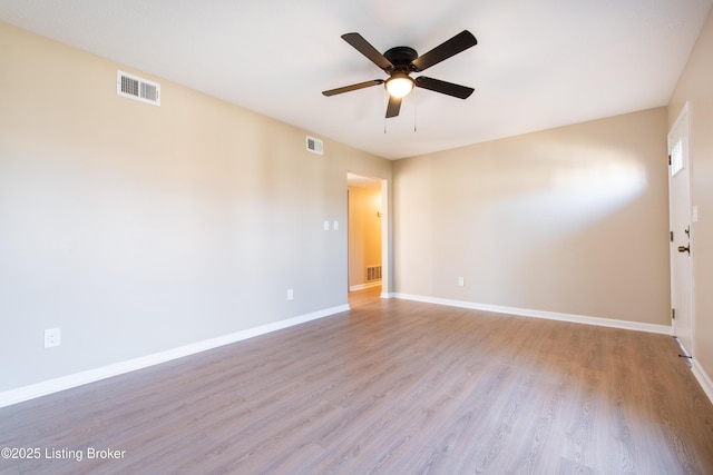 spare room with ceiling fan and light wood-type flooring