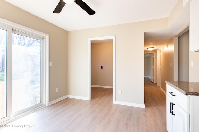 unfurnished room with ceiling fan and light hardwood / wood-style flooring