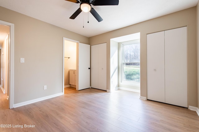 unfurnished bedroom with ensuite bathroom, ceiling fan, and light wood-type flooring