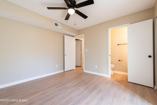 unfurnished bedroom featuring ensuite bathroom, light hardwood / wood-style flooring, and ceiling fan