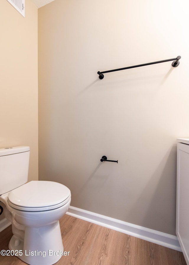 bathroom featuring hardwood / wood-style floors and toilet