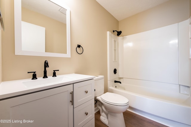 full bathroom featuring shower / bathing tub combination, vanity, toilet, a textured ceiling, and wood-type flooring