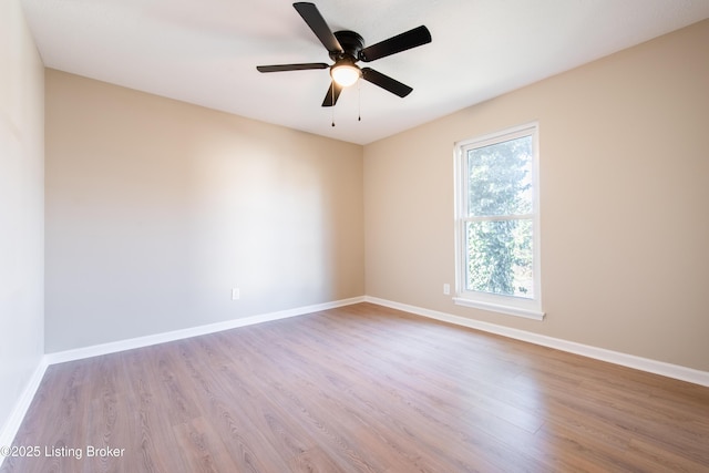 empty room with ceiling fan, light hardwood / wood-style flooring, and plenty of natural light