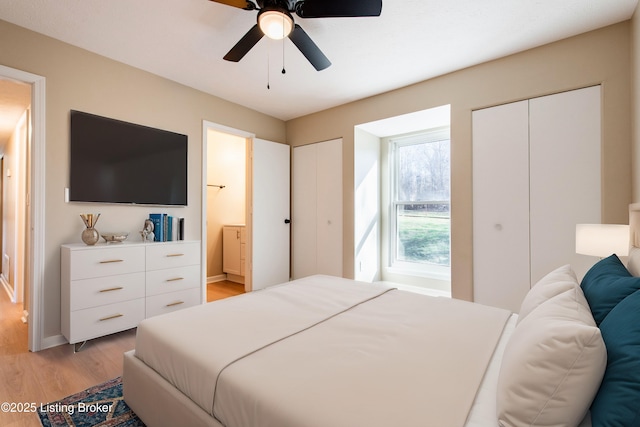 bedroom with connected bathroom, light hardwood / wood-style flooring, and ceiling fan