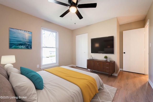 bedroom with ceiling fan and light hardwood / wood-style floors