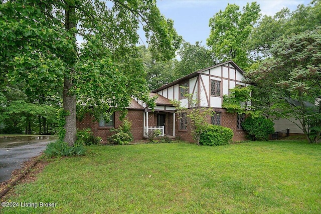 english style home with a front yard