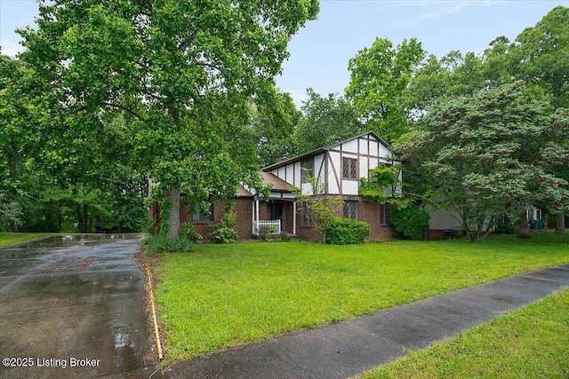 tudor home with a front yard