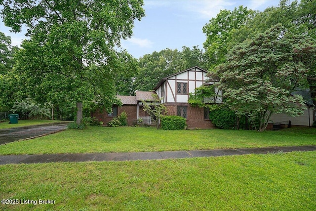 tudor home featuring a front yard