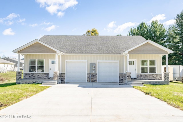 view of front of property with a front yard and a garage