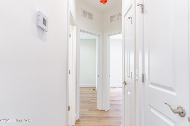 corridor with light hardwood / wood-style floors