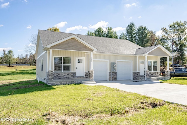 view of front of home with a front yard and a garage