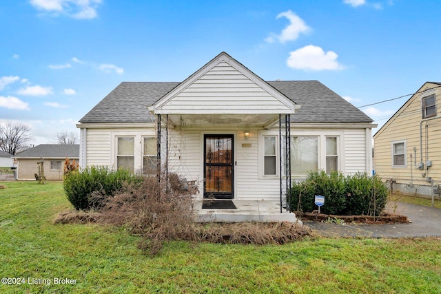 bungalow-style house featuring a front yard