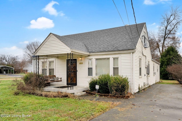 view of front of property with covered porch and a front yard