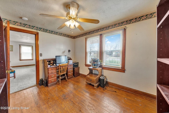 office with ceiling fan, a textured ceiling, and hardwood / wood-style flooring