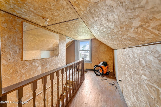 interior space featuring hardwood / wood-style floors and lofted ceiling