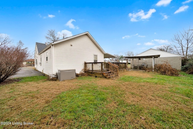 back of property featuring a lawn and a deck