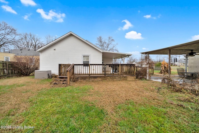 back of house featuring ceiling fan, a yard, and a wooden deck