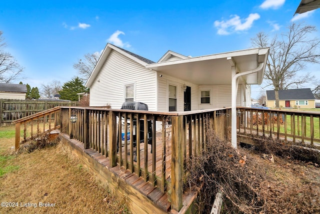 rear view of house featuring a wooden deck