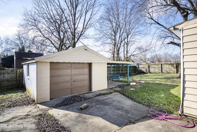 garage featuring a lawn