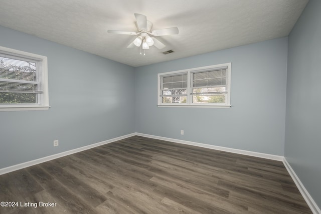 unfurnished room with a textured ceiling, ceiling fan, and dark hardwood / wood-style floors