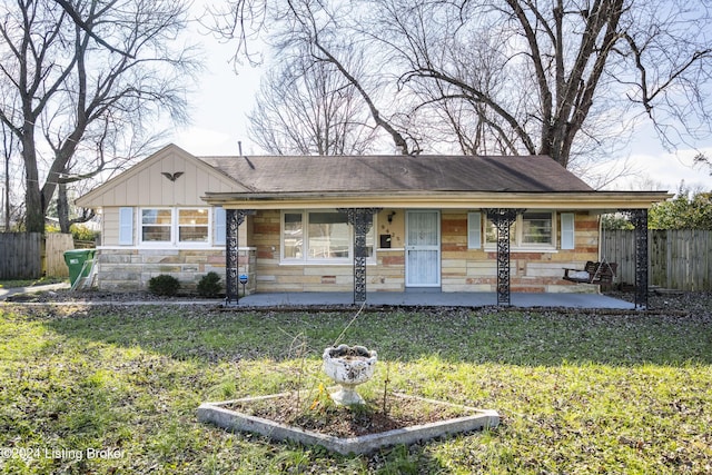 ranch-style home featuring a front yard and a porch