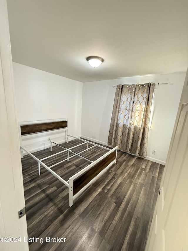 unfurnished bedroom featuring dark wood-type flooring