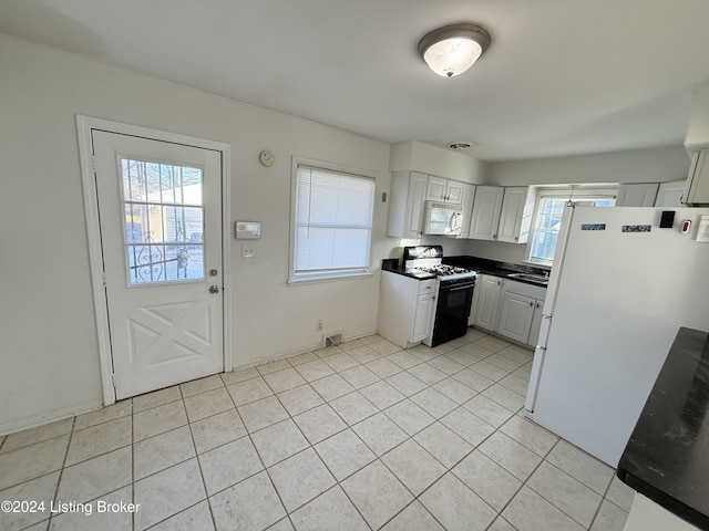 kitchen with white appliances, white cabinetry, a wealth of natural light, and sink