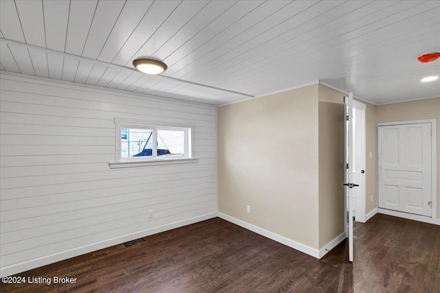 basement with dark hardwood / wood-style flooring