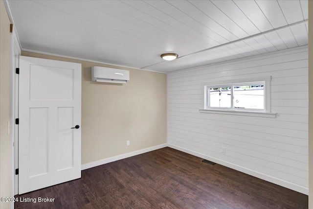 basement featuring dark hardwood / wood-style floors and an AC wall unit