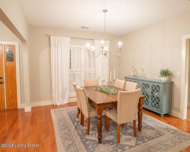 dining space featuring a notable chandelier and hardwood / wood-style flooring