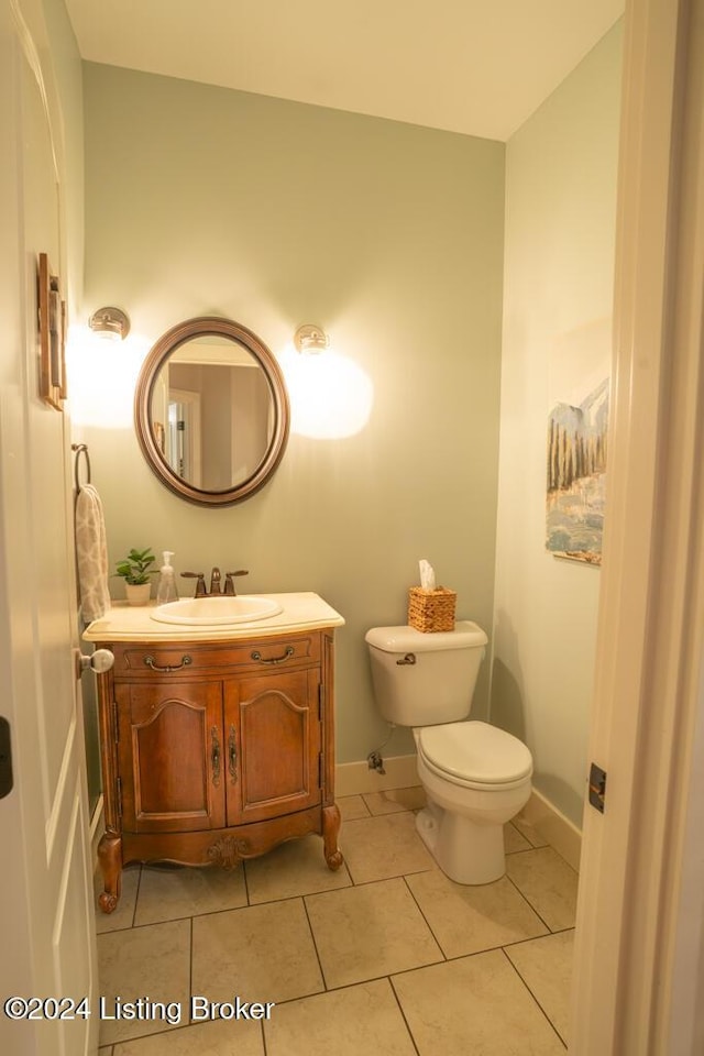 bathroom with tile patterned floors, vanity, and toilet