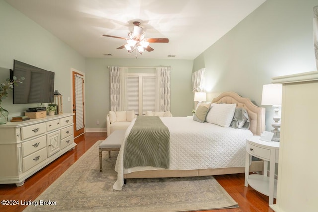 bedroom with ceiling fan and dark wood-type flooring