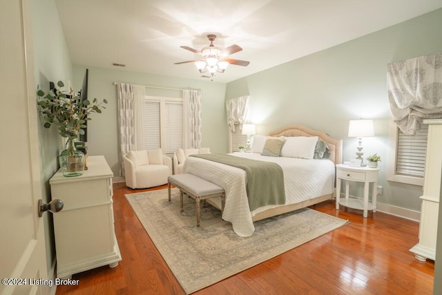 bedroom with wood-type flooring and ceiling fan