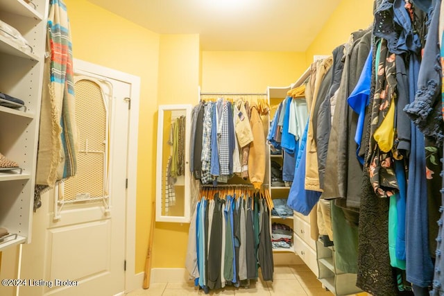 spacious closet with light tile patterned floors