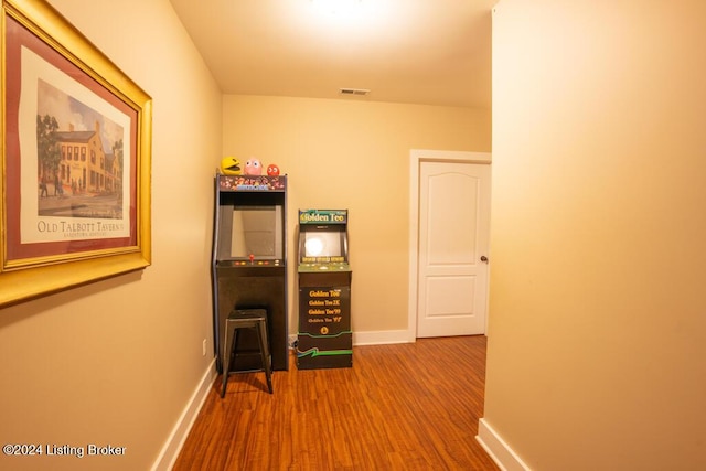 corridor with hardwood / wood-style flooring