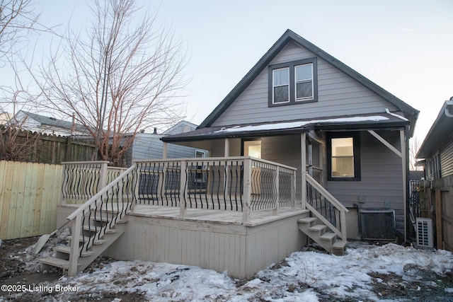 snow covered house with central air condition unit