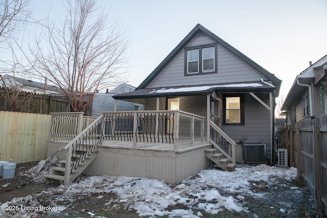 snow covered house with central AC