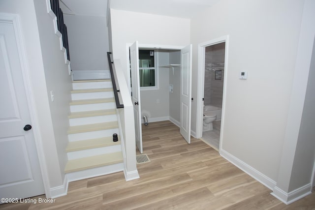 stairs with wood-type flooring