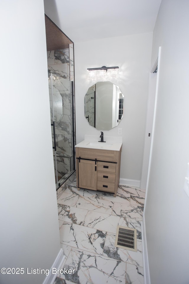 bathroom featuring walk in shower and vanity