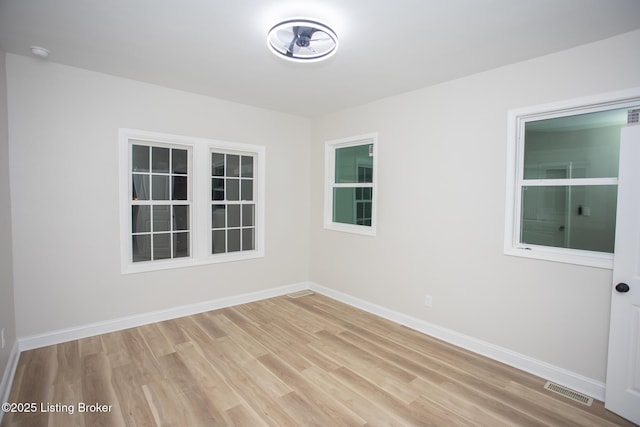 unfurnished room with light hardwood / wood-style floors