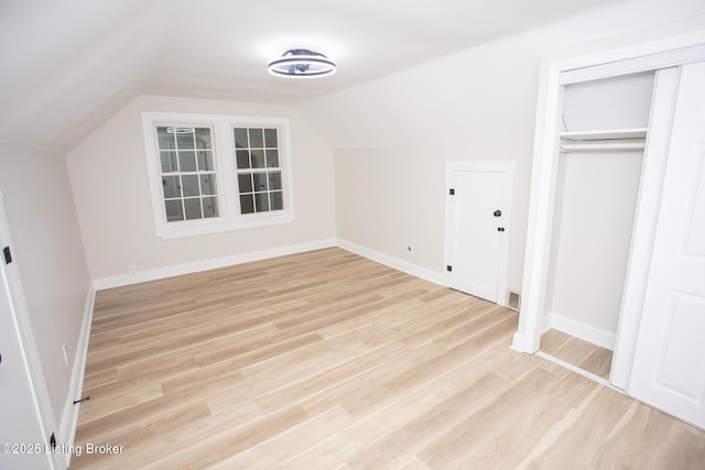 bonus room featuring vaulted ceiling and light hardwood / wood-style floors